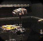 Reaction wheel and thruster 6-DOF platforms moving in the Caltech Autonomous Robotics and Control Lab during an autonomy demonstration. Credit Okean Solutions.